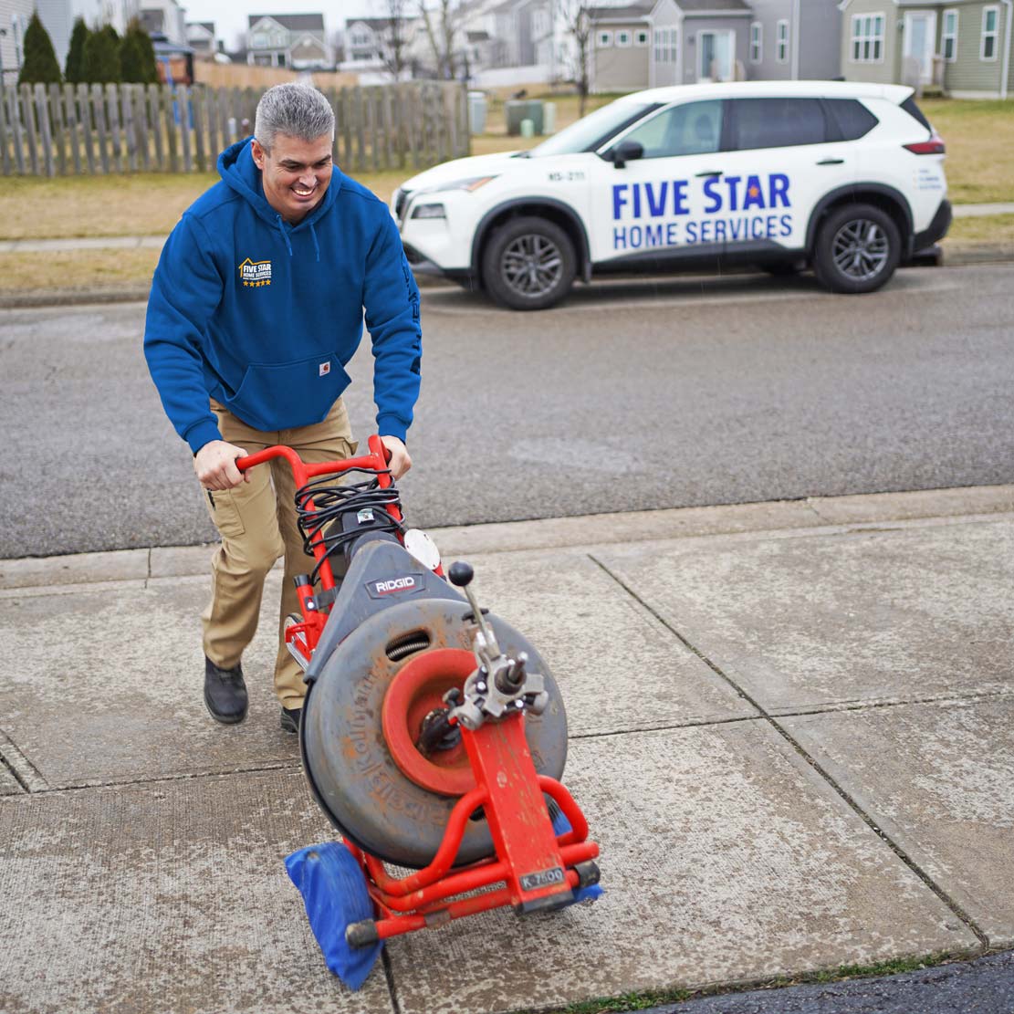 Plumber with a Hydro Jet walking