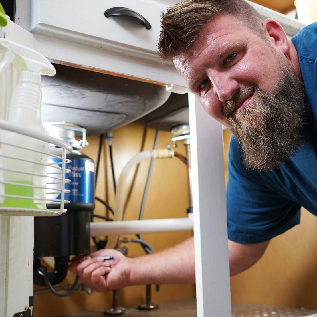 Plumber Fixing a Garbage Disposal