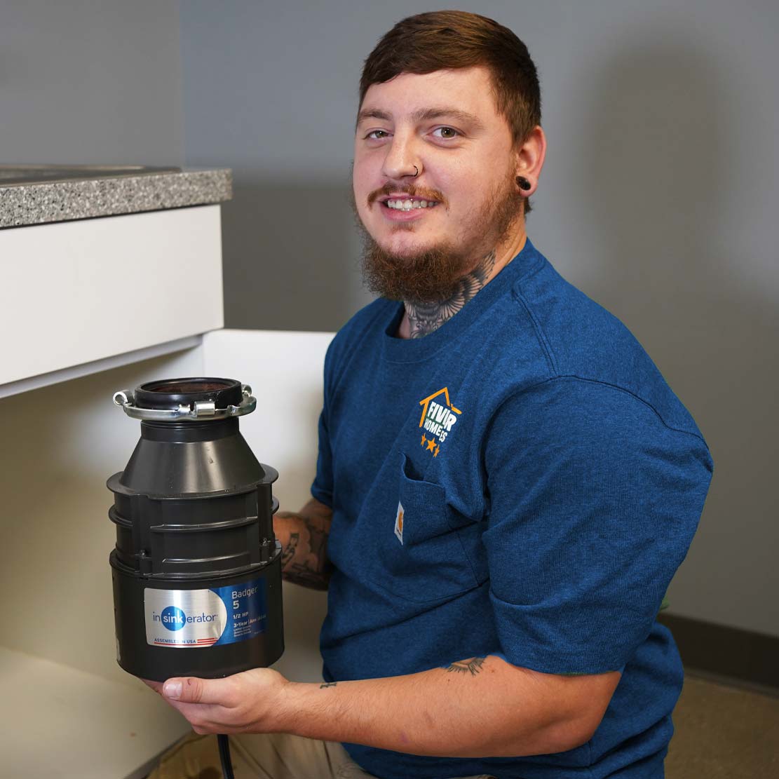 Plumber Holding a Garbage Disposal