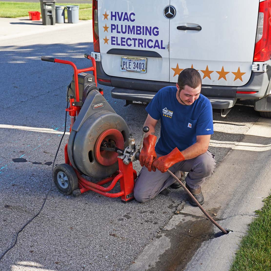 Plumber with a Hydro Jetter cleaning a sewer line