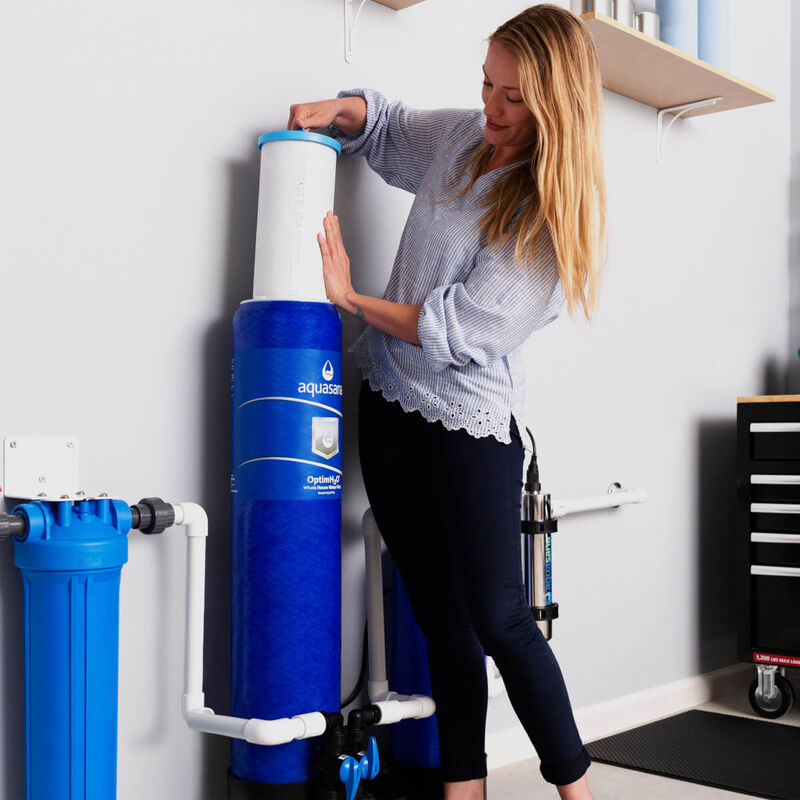 Woman Replacing a Filter for a Water Treatment System