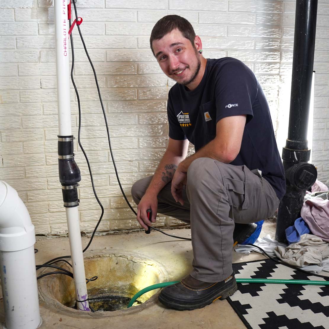 Plumber Fixing a Sump Pump