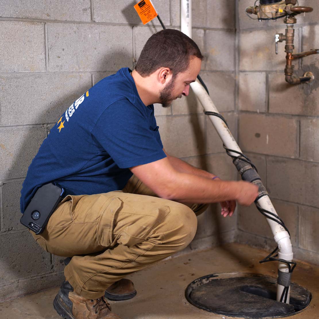 Plumber Fixing a Sump Pump